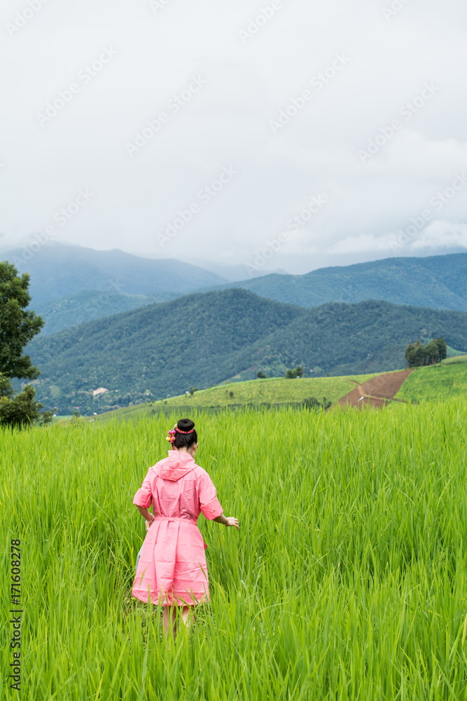 Asian woman relaxing in rice terraces fields on holiday