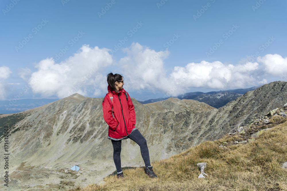 Happy hiker woman on the top of a mountain with stunning view.Musala peak in RIla mountain