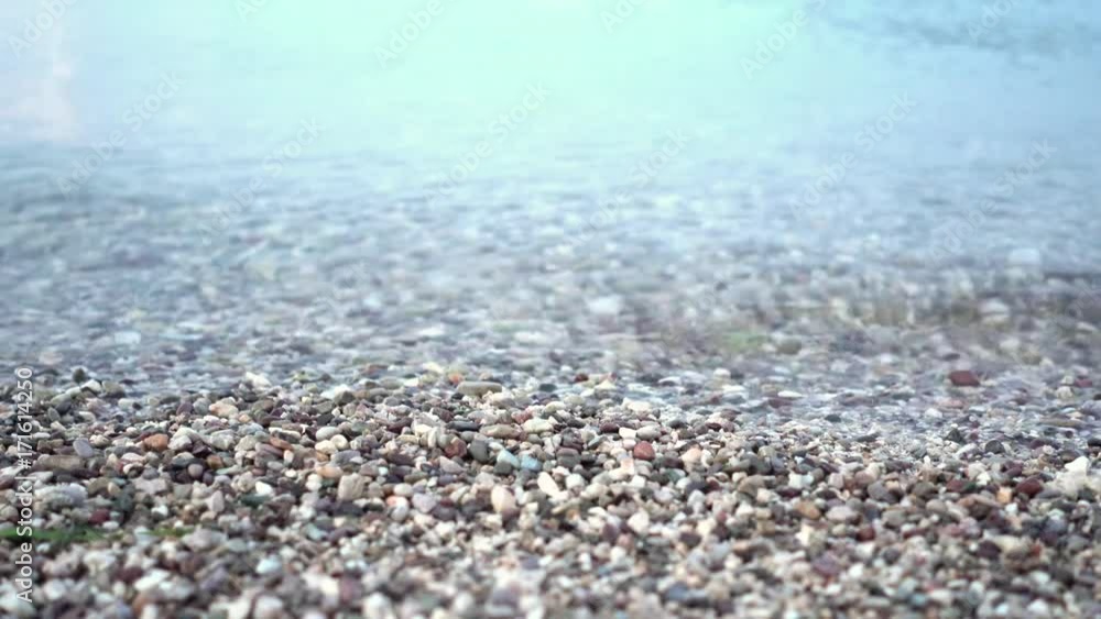 Relaxing scene of waves and gravels in shallow sea water surface Relaxing scene of waves and gravels in shallow sea water surface