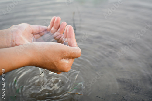 Close up hand of girl and nature water