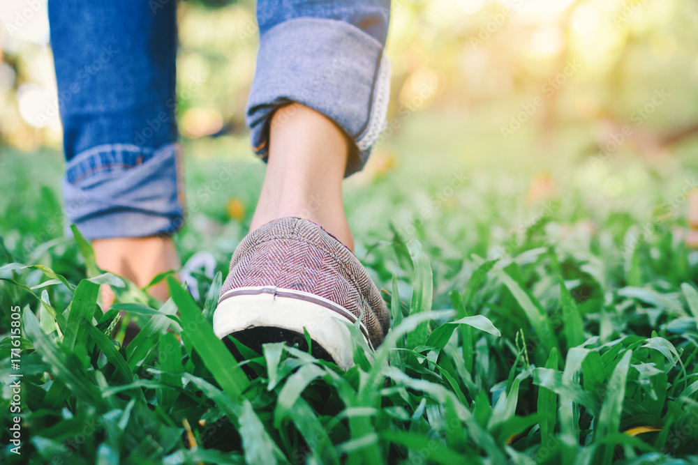 Feet of hipster girl walking in forest background, Relax time on holiday Feet of hipster girl walking in forest background, Relax time on holiday