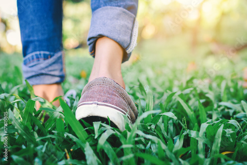 Feet of hipster girl walking in forest background, Relax time on holiday