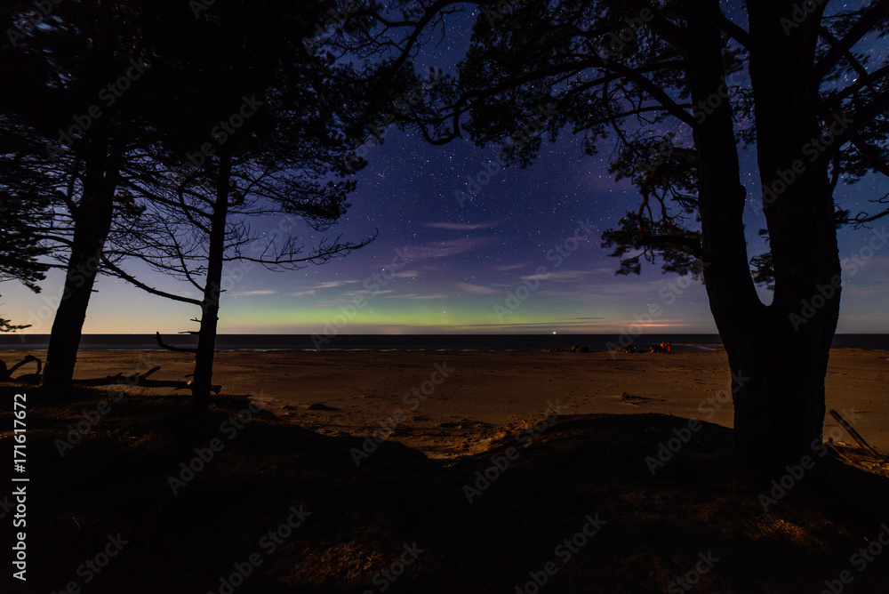 intense northern lights aurora borealis over beach