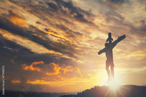 Fotografija Silhouette of Jesus christ crucifix on cross over heaven sunset concept for cath