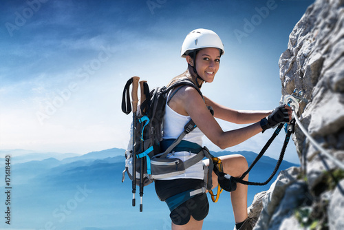 Woman climber on a Klettersteig (Via Ferrata) photo