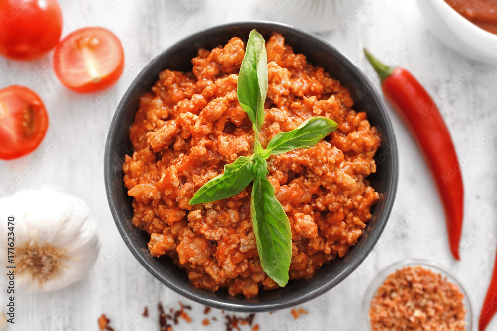 Meat sauce in ceramic bowl on kitchen table Meat sauce in ceramic bowl on kitchen table