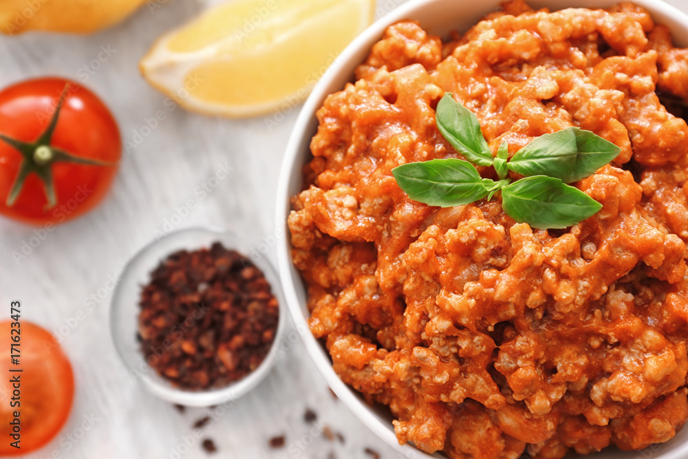 Meat sauce in ceramic bowl on kitchen table Meat sauce in ceramic bowl on kitchen table