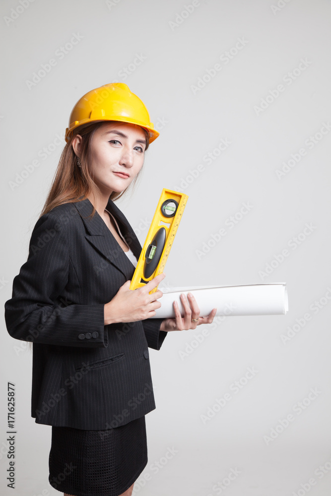 Asian engineer woman with blueprints and level. Asian engineer woman with blueprints and level.
