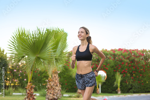 Young beautiful woman runni...
