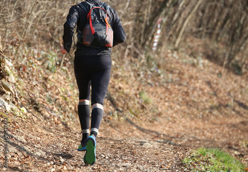 legs of a runner during the country race in the middle of the fo