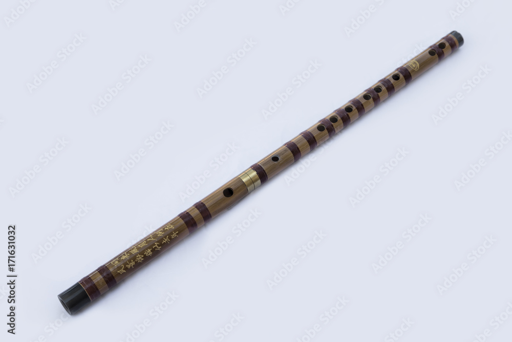 Chinese dizi flute laying diagonally on a white background Chinese dizi flute laying diagonally on a white background