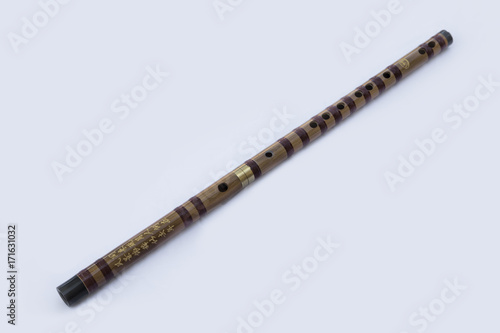Chinese dizi flute laying diagonally on a white background photo