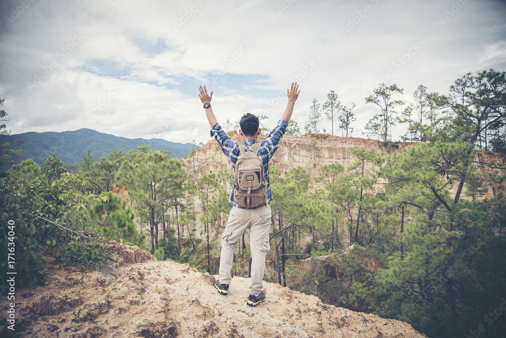 Obraz premium Happy hiker with her arms outstretched, freedom and happiness, achievement in mountains