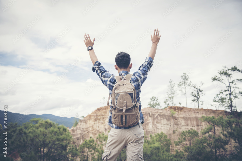 Happy hiker with her arms outstretched, freedom and happiness, achievement in mountains