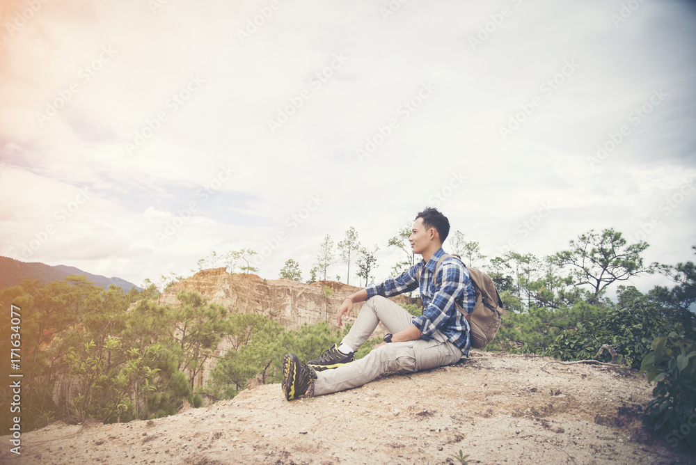 young male backpacker enjoy the view at mountain peak young male backpacker enjoy the view at mountain peak