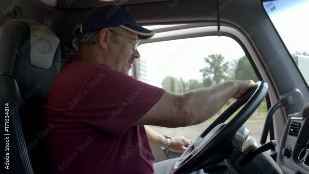 Truck driver opens door and gets out from behind the wheel in daylight interior, summer day. Hand-held slow motion 4K recorded at 60fps. Truck driver opens door and gets out from behind the wheel in daylight interior, summer day. Hand-held slow motion 4K recorded at 60fps.