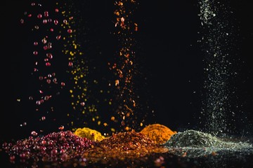 Powdered spices against black background