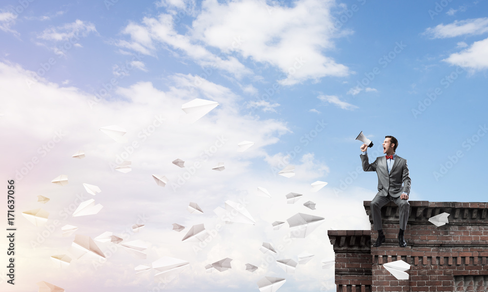 Businessman or manager announcing something in loudspeaker and paper planes fly around Businessman or manager announcing something in loudspeaker and paper planes fly around
