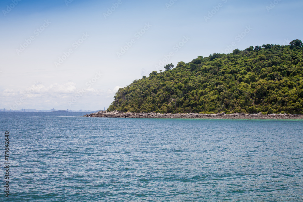 tropic Island in the sea with copy space. Useful illustration or background for travel article or holiday content tropic Island in the sea with copy space. Useful illustration or background for travel article or holiday content