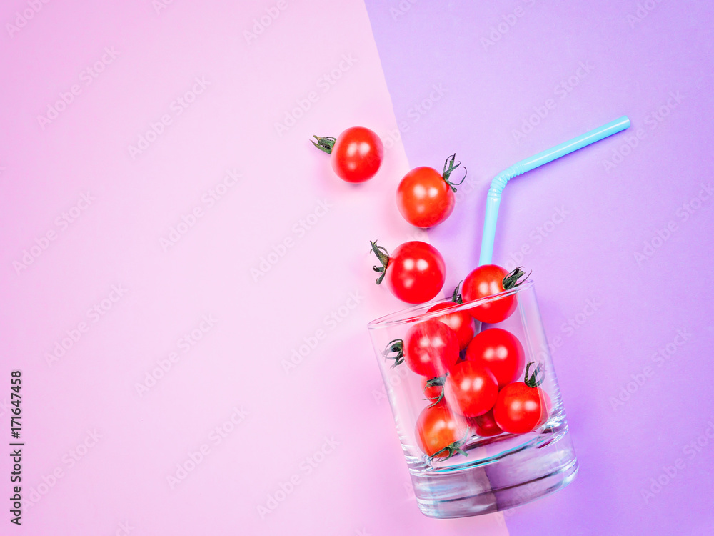 Fototapeta premium Tomato juice or smoothie, cherry tomato in drink glass with straw
