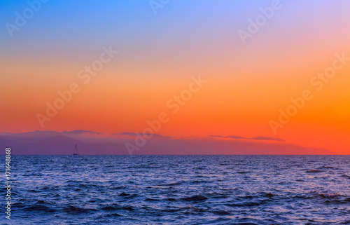 sailboat at sunrise photo