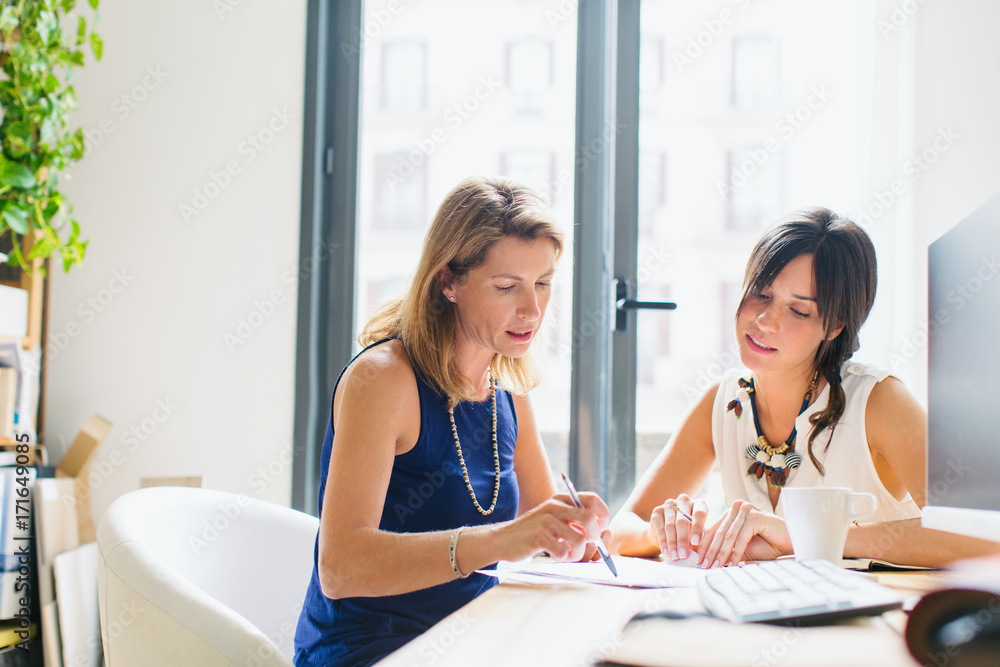 Businesswomen working together in office Businesswomen working together in office