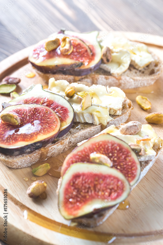Slices of bread with camembert, figs and pistachios Slices of bread with camembert, figs and pistachios