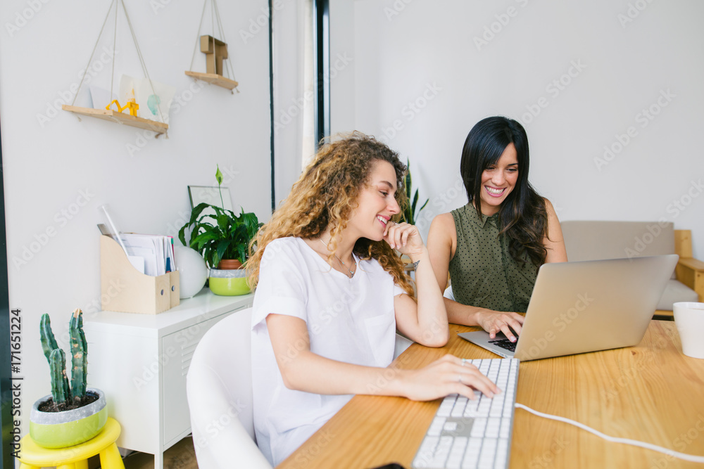 Young entrepreneurs working in a beautiful studio. Young entrepreneurs working in a beautiful studio.