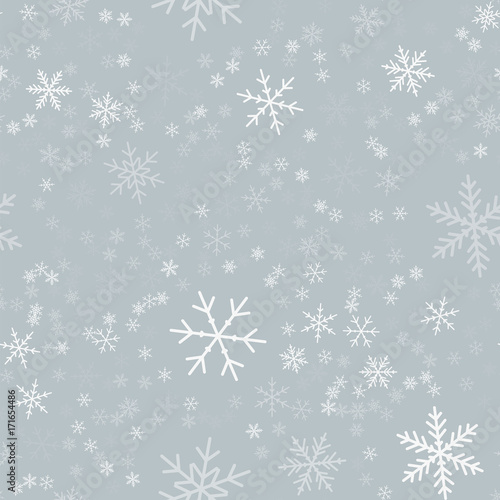 White snowflakes seamless pattern on light grey Christmas background. Chaotic scattered white snowflakes. Mesmeric Christmas creative pattern. Vector illustration.