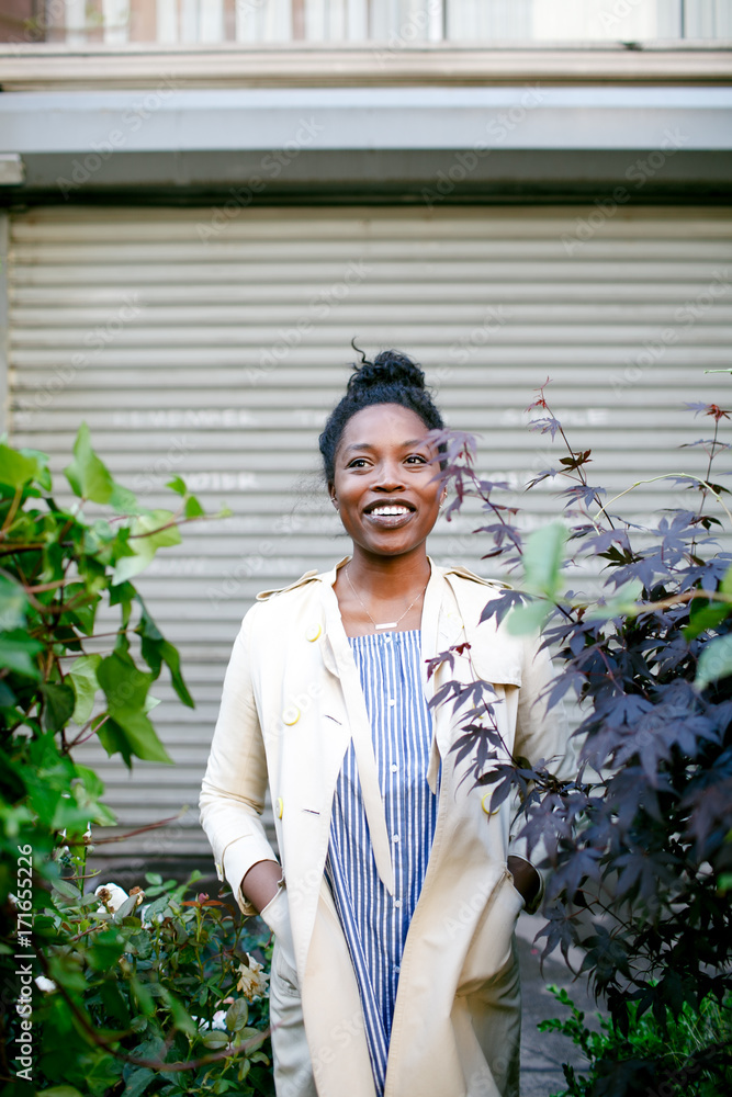 Beautiful woman standing between plants Beautiful woman standing between plants