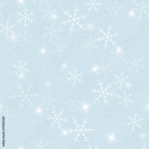 Magic snowflakes seamless pattern on light blue Christmas background. Chaotic scattered magic snowflakes. Radiant Christmas creative pattern. Vector illustration.