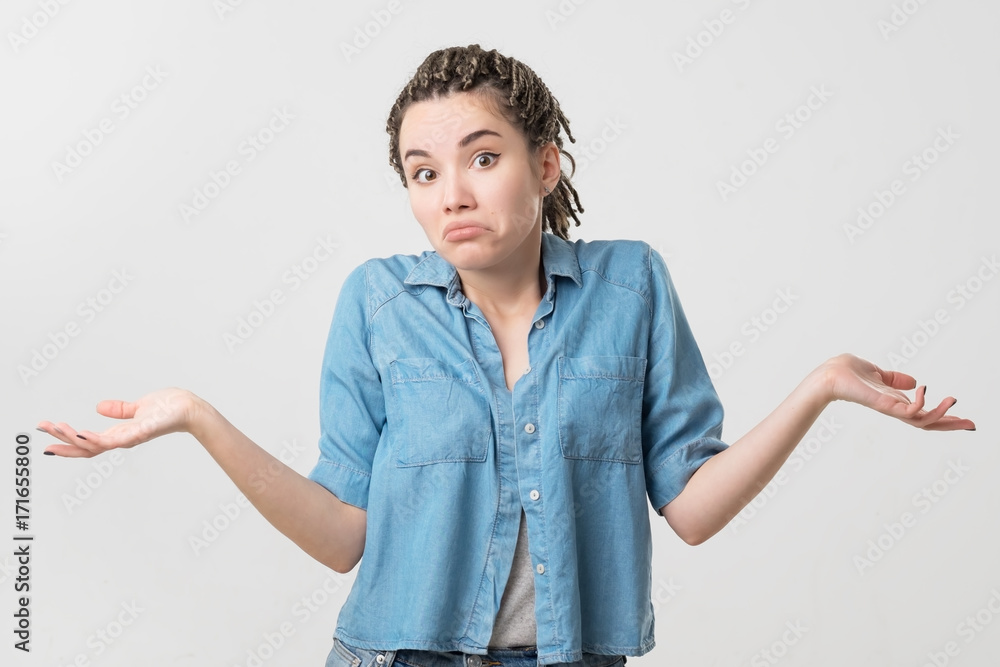 Portrait of caucasian girl with braids having doubtful and indecisive face expression. Portrait of caucasian girl with braids having doubtful and indecisive face expression.