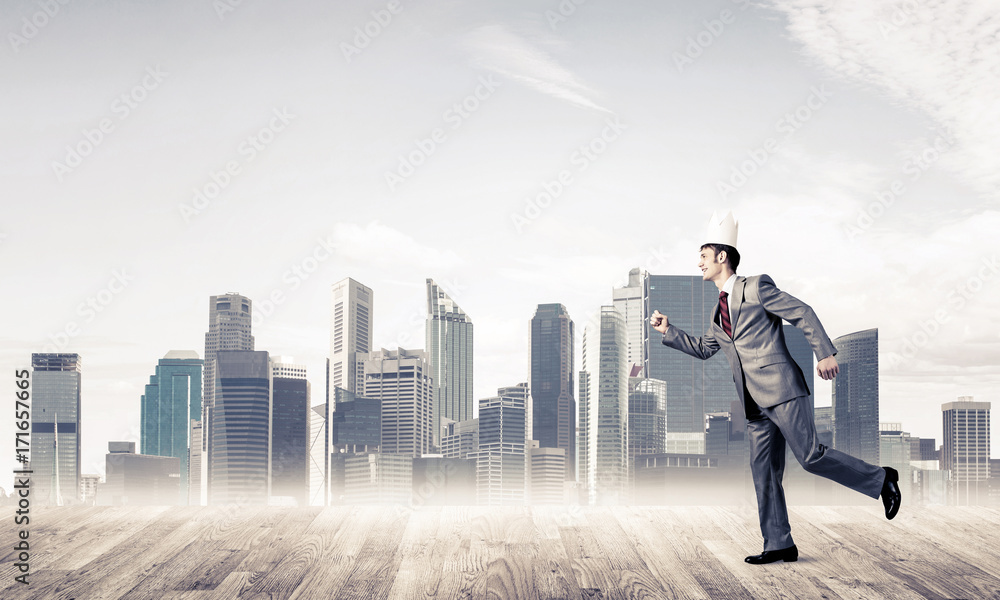 King businessman in elegant suit running and modern cityscape at King businessman in elegant suit running and modern cityscape at