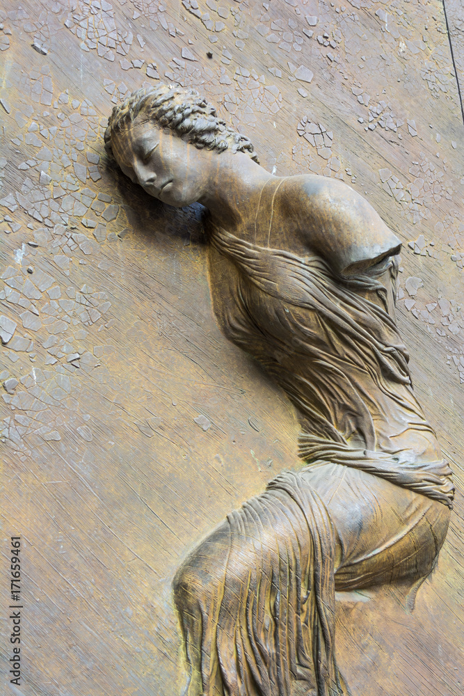 Bronze statue on the door of the Basilica of St. Mary of the Angels and the Martyrs - Rome, Italy Bronze statue on the door of the Basilica of St. Mary of the Angels and the Martyrs - Rome, Italy