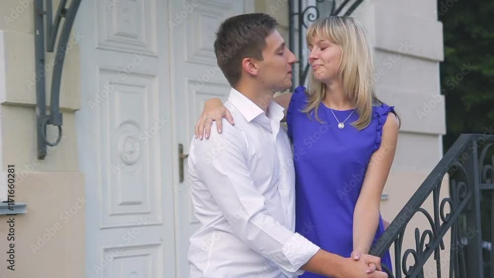 loving young couple walking around town man in white shirt and girl in blue dress loving young couple walking around town man in white shirt and girl in blue dress