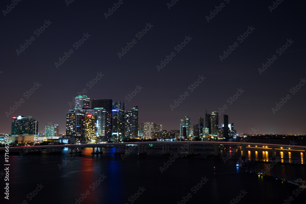 Miami at night. View from atop a glowing building with a bridge