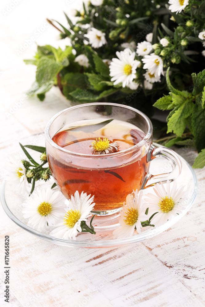cup of tea with chamomile flowers on rustic background cup of tea with chamomile flowers on rustic background