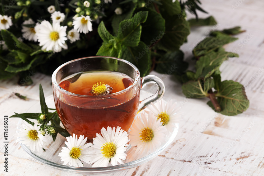 cup of tea with chamomile flowers on rustic background cup of tea with chamomile flowers on rustic background
