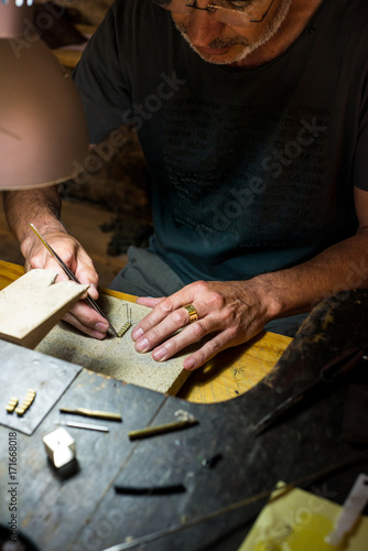 Jeweler making a necklace on his wokshop