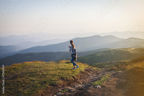 Girl Hiker Walks into Mountains