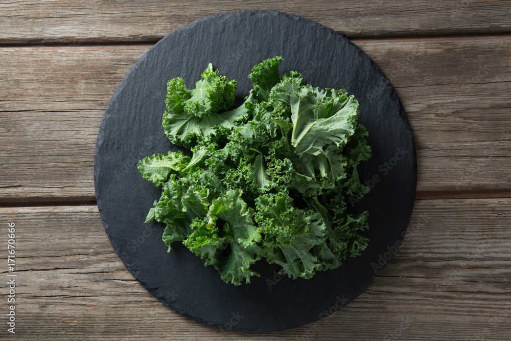 Overhead view of kale on plate over table Overhead view of kale on plate over table