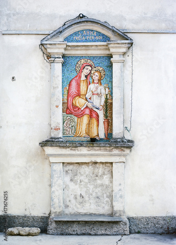 Ancient holy aedicule in italian narrow street