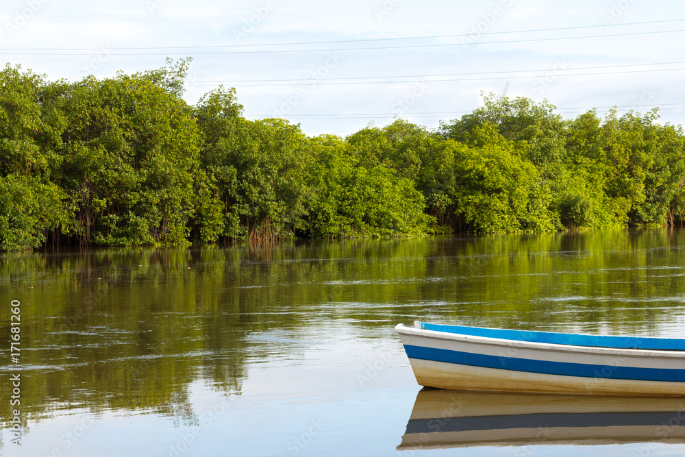 Obraz premium Boat reflection in calm river water.