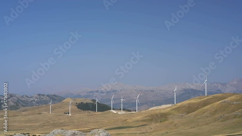 Windmills converting wind energy into electricity photo