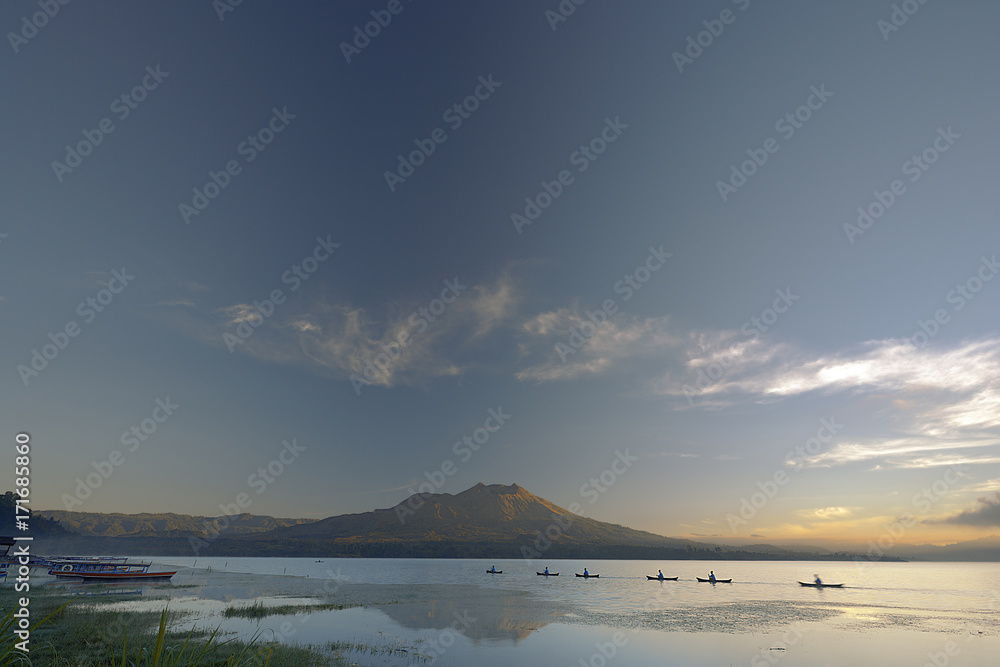 KINTAMANI, BALI, INDONESIA–JUNE 4 : Fishing boats dock in the lake at dawn on June 4, 2006 in Kintamani lake, Bali, Indonesia. Kintamani lake is the largest lake in Bali.