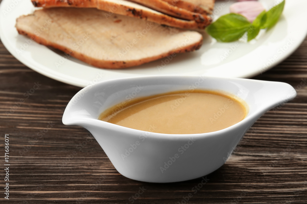 Sauce boat with tasty turkey gravy on table Sauce boat with tasty turkey gravy on table
