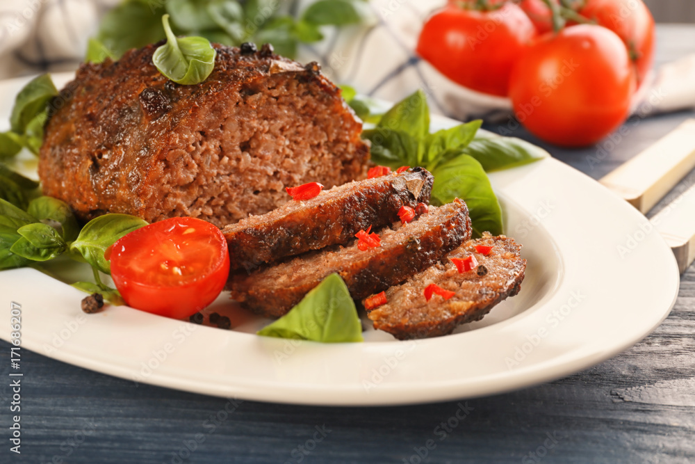 Plate with tasty baked turkey meatloaf on table