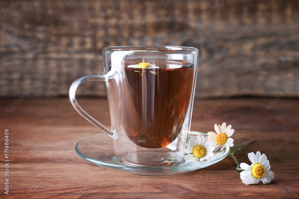 Cup of chamomile tea on wooden background Cup of chamomile tea on wooden background