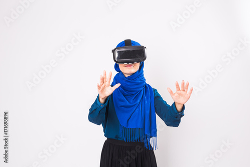 Muslim woman using VR headset. technology, vr, people and game concept