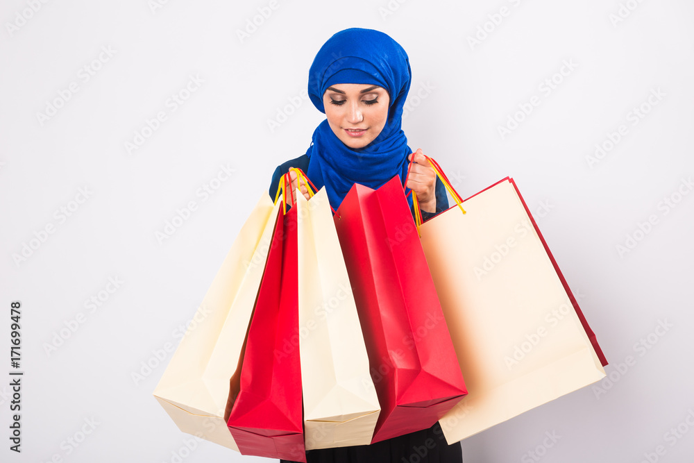 Happy young muslim woman with shopping bag on white background Happy young muslim woman with shopping bag on white background